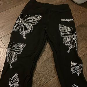 Black sweatpants with rhinestone butterflies